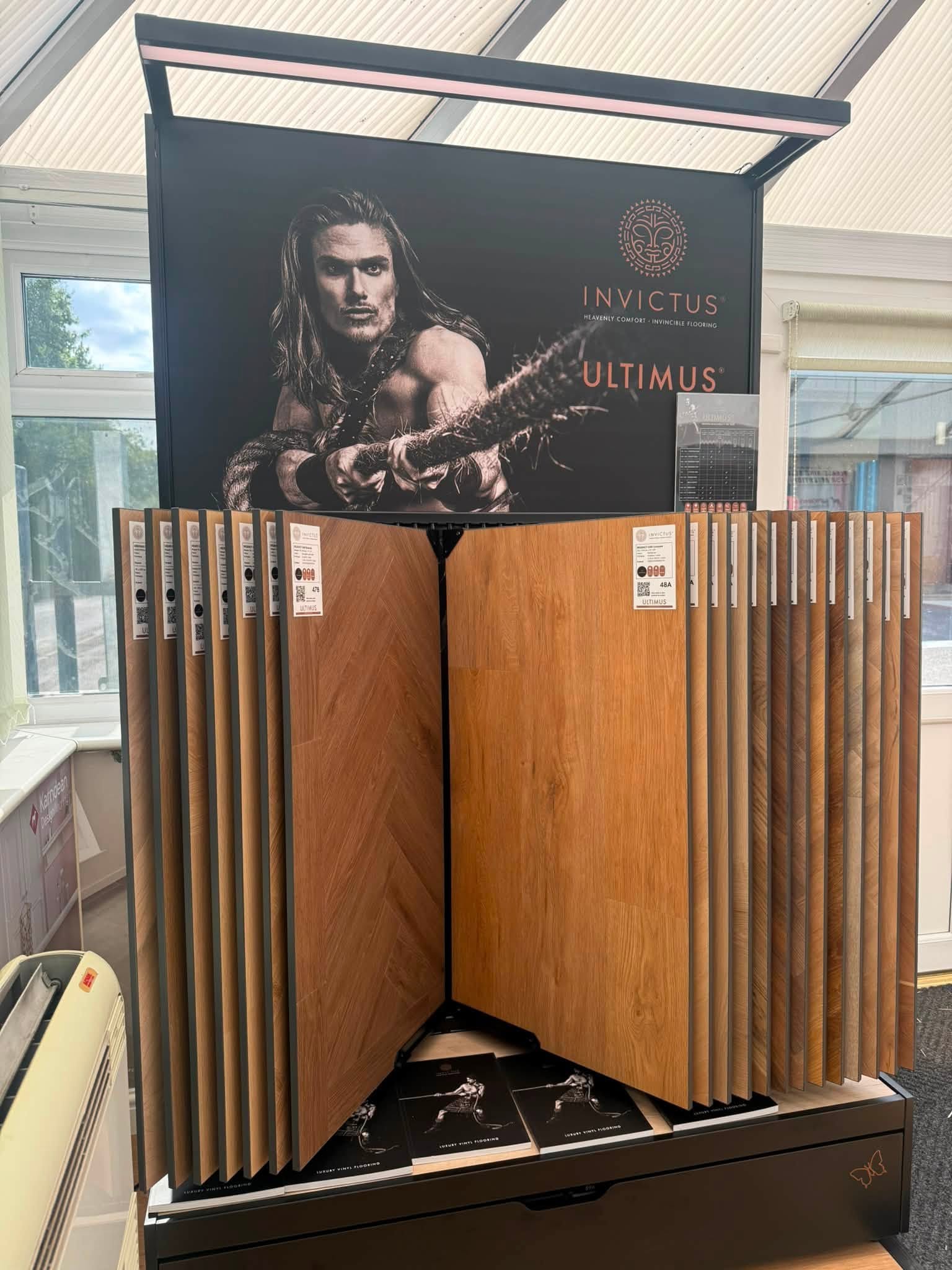 Invictus Ultimus wood-effect flooring samples on display in the showroom