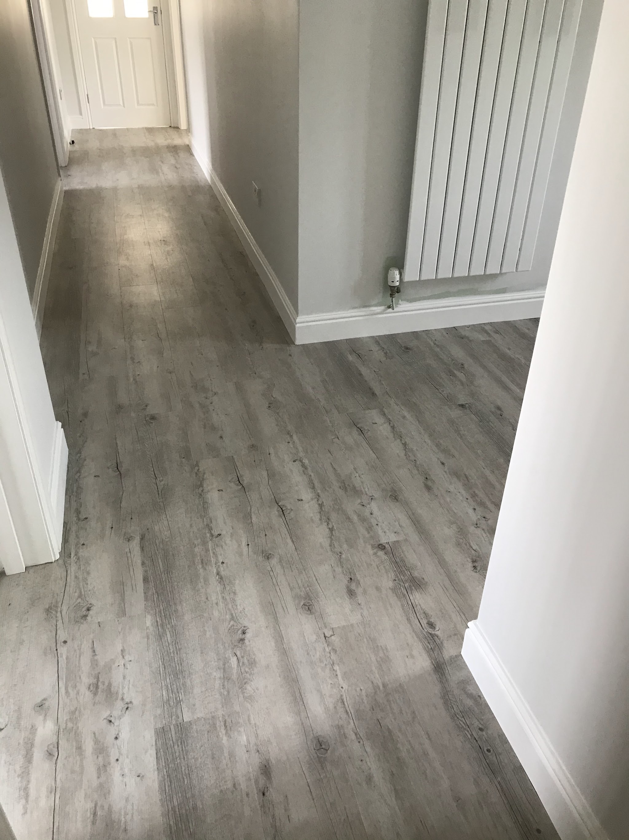 A grey wood-effect Karndean floor laid along a hallway