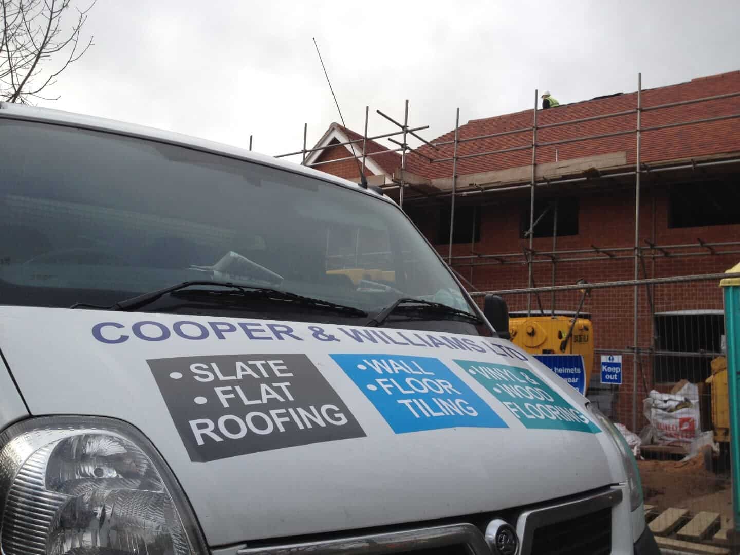 A Cooper & Williams van on a roofing job, advertising slate and flat roofing